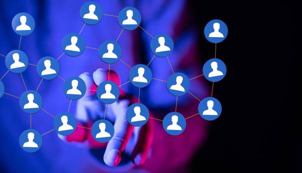 istock Person pointing at network icons on a dark background 1455201038