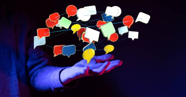 istock Person holding message icons on a dark background 1455201064