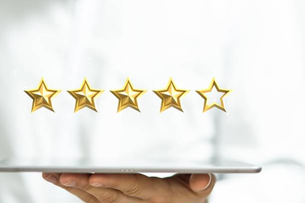 istock Person holding star icons on a tablet 1455201070