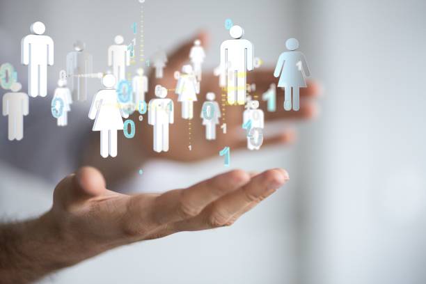 istock Social networking scheme of 3D rendered digital human icons with binary digits over a person's hands 1455202364