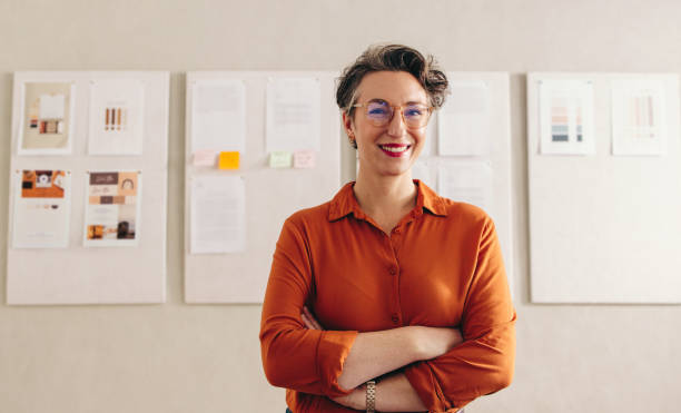 istock Happy designer smiling at the camera in her office 1455203336