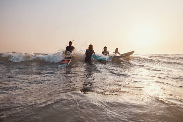 istock Young surfers surfing in the sea. 1455203833