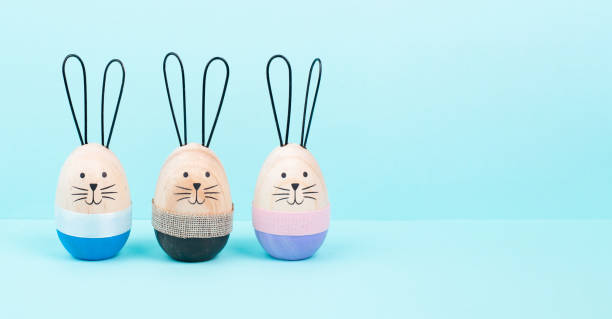 istock Easter bunny or rabbit group, holiday background and greeting card, painted wooden egg 1455203855