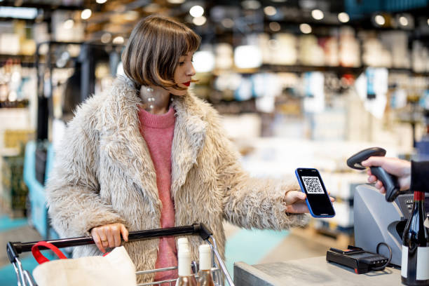 Woman buying with QR code stock photo