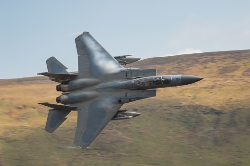 Dolgellau, United Kingdom – March 02, 2022: A closeup shot of a F15 flying in the Mach Loop Wales