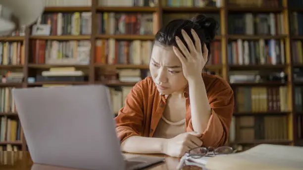 Young asian woman frustrated with too much studying, stress, academic pressure