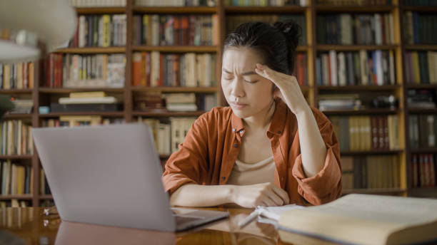 istock Tired female writer having headache, resting from work on laptop, eyestrain 1455207871