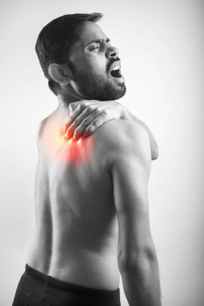 istock man holding his scapula pain point with red highlight glow 1455209805