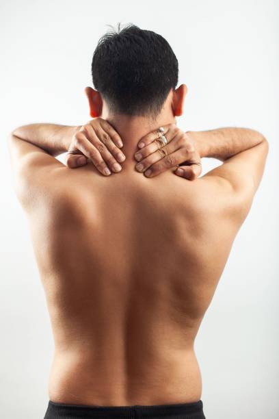 rear view of man with neckache, spine injury, back pain - lumbar vertebra imagens e fotografias de stock