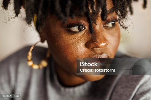 istock Young woman looking away, contemplating her New Year's resolutions 1455211526