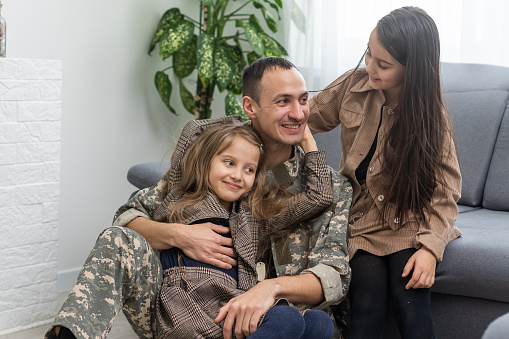 Happy military father holding daughter. family, bonding and patriotism,