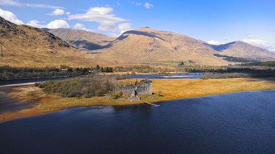 An aerial view of the Kilchurn castle ruins in Hills of west Highlands, Scotland