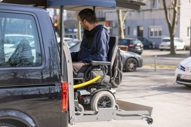 istock Man with disability using wheelchair lift to get in the van 1455213027
