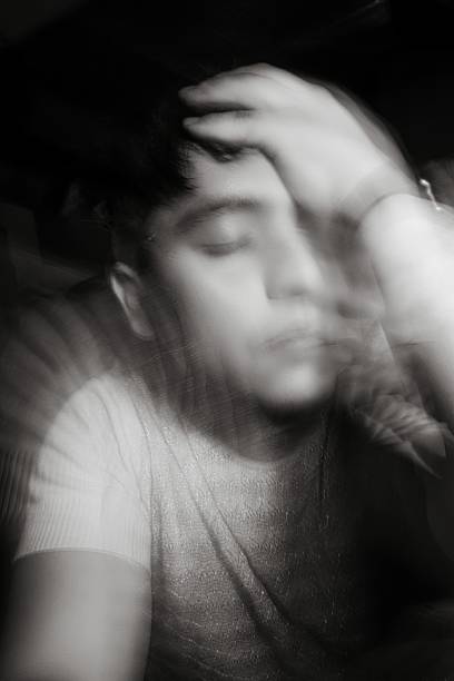 istock Portrait Of Man Amidst Multi Colored Lights with long exposure At Night 1455213267