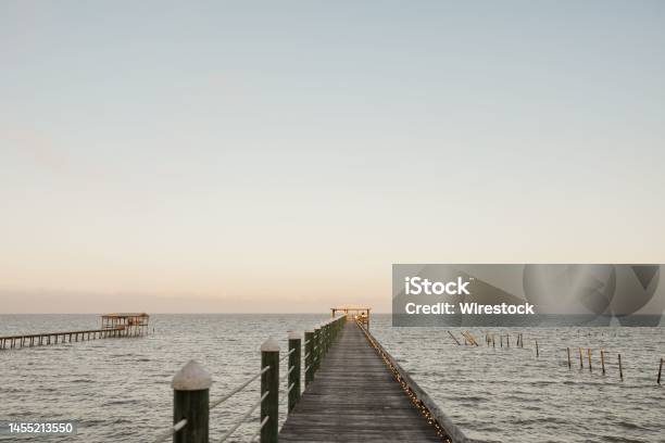 Scenic View Of Wooden Piers On The Seascape On A Sunny Day In Fairhope Alabama Stock Photo - Download Image Now