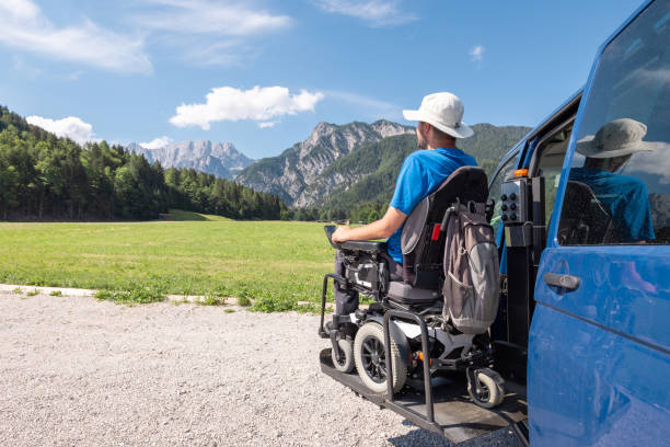 istock Man with disability getting off a van, using a wheelchair lift 1455213581