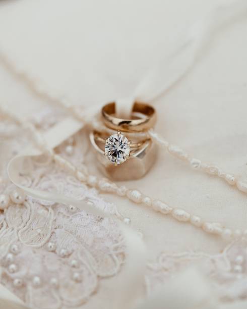 istock Closeup of luxury wedding rings on a white pillow 1455214207