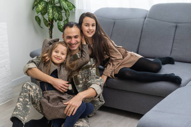 istock military father and two daughters at home 1455214857