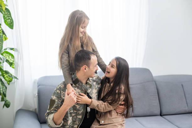 istock military father and two daughters at home 1455215054