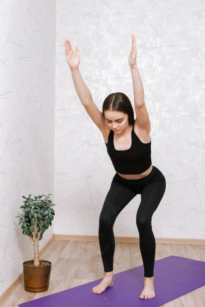istock Tranquil female practicing yoga on exercise mat in apartment 1455223981