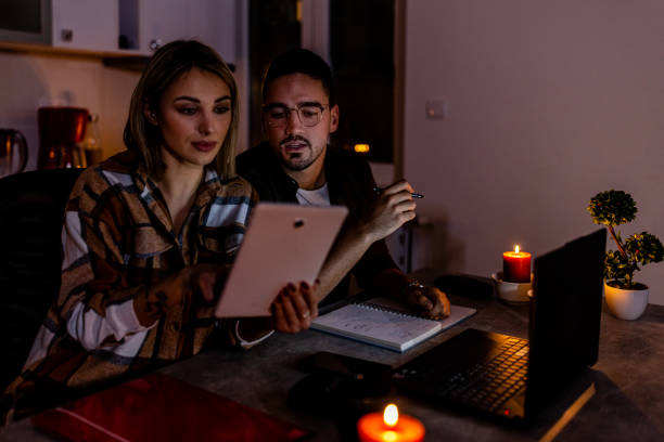 istock A young couple is working at home during blackout time during an energetic crisis. 1455224154
