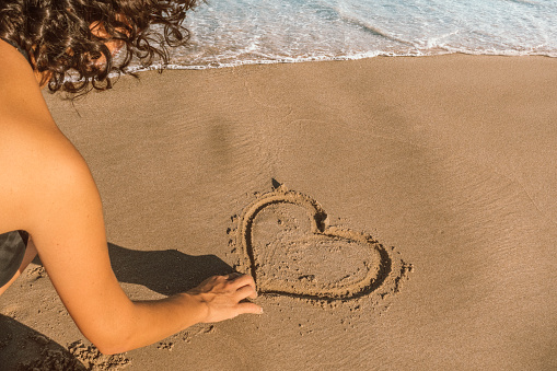 drawing heart on sand