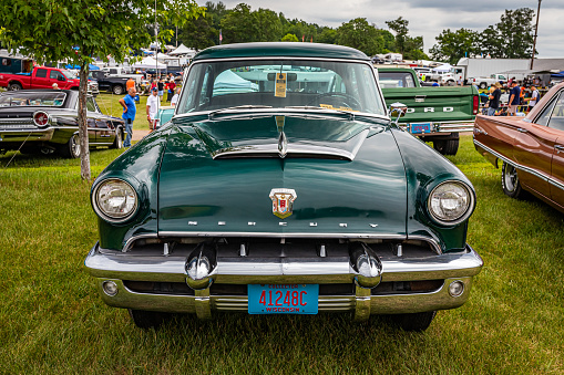 Iola, WI - July 07, 2022: High perspective front view of a 1953 Mercury Monterey 4 Door Sedan at a local car show.