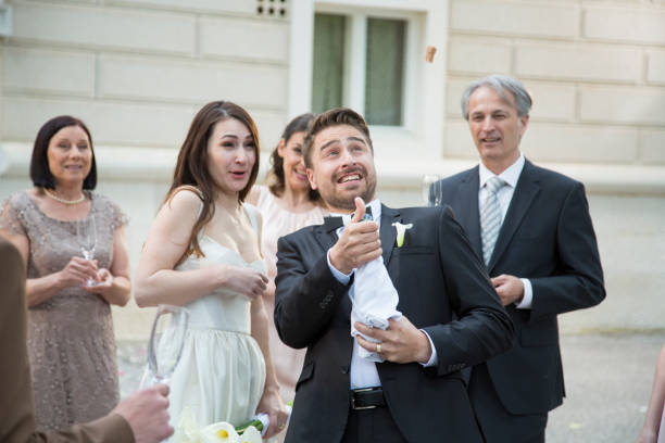 istock Groom opening champagne on his wedding 1455227020