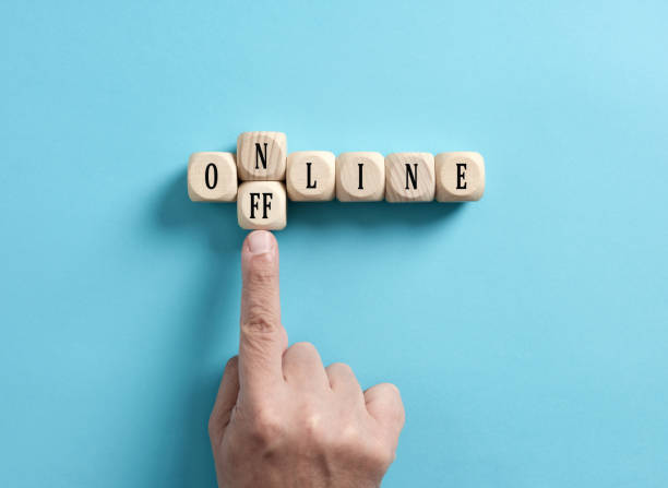 Going offline. To choose between online and offline. Digital detox. Going offline. To choose between online and offline. Digital detox. Male hand transforms the word online to offline on wooden cubes. offline stock pictures, royalty-free photos & images