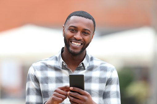 Happy black man looks at camera