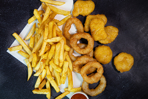 Over head shot of onion rings chicken nuggets and chips