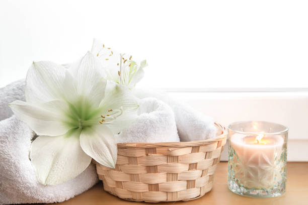 istock Spa composition with lily flowers and towels in a basket. 1455228430