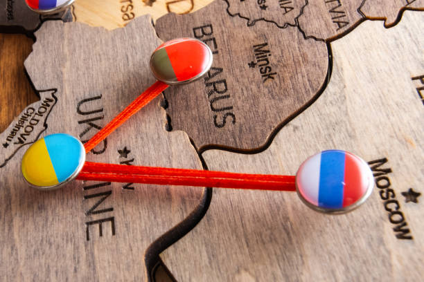 istock Pins with flags and threads on the wooden maps demonstrate Russia and Belarus aggression in Ukraine 1455230074