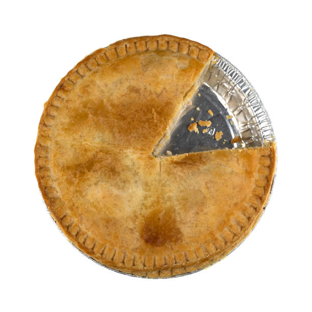Overhead view of a chicken meat pie with one slice missing isolated on a white background.