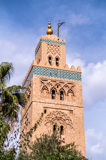 Minaret of a mosque in Marrakech, Morocco. From the minaret of a mosque the five daily calls to prayer for people of the Islamic religion are made.