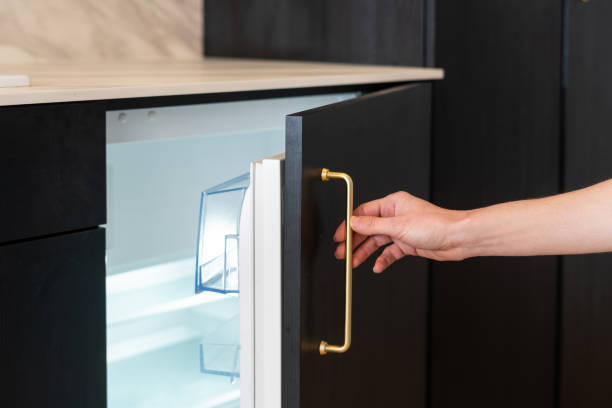 istock woman open empthy mini refrigerator indoors, closeup 1455232636