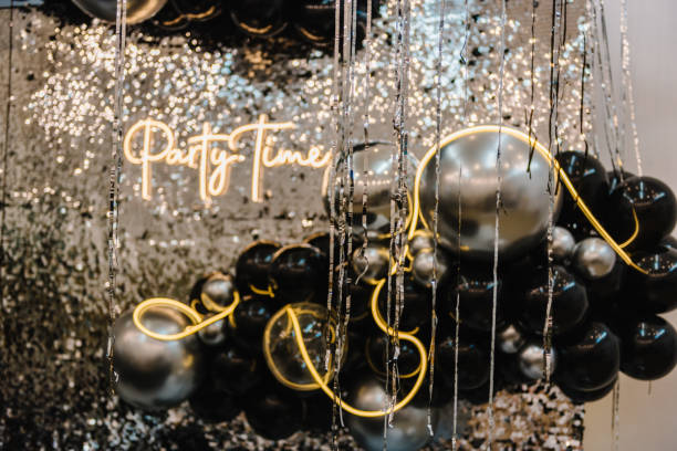 istock Arch or photo booth decorated black and silver balloons and led strips. Zone with decor sparkling sequins for wedding. A place for congratulations for birthday. Text party time. Happy New Year 2023. 1455233533