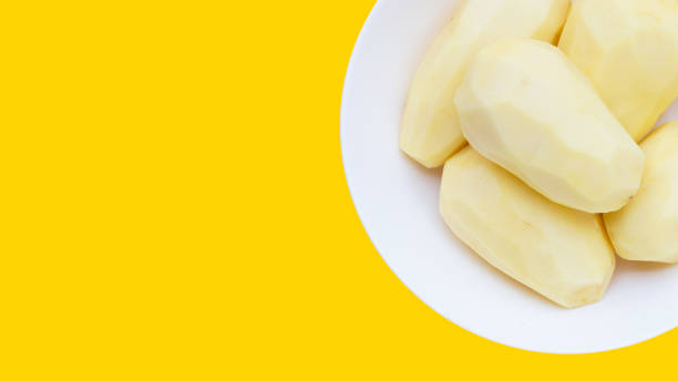istock Raw peeled potatoes on white background 1455233878