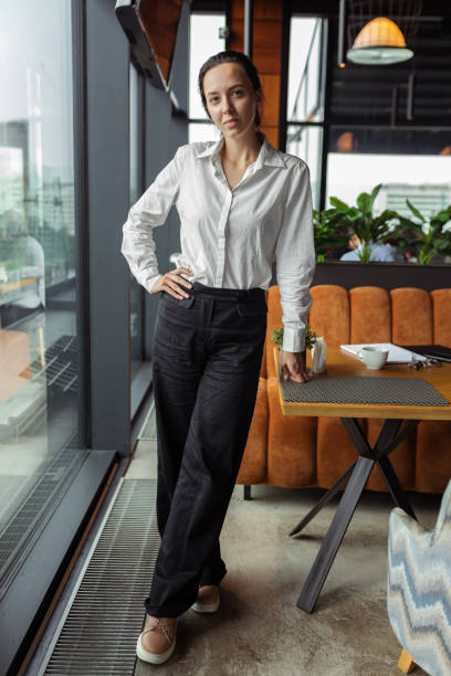 istock Confident restaurant manager standing in cafe 1455235291