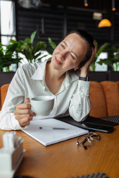 istock Cheerful businesswoman drinking coffee in restaurant 1455235328