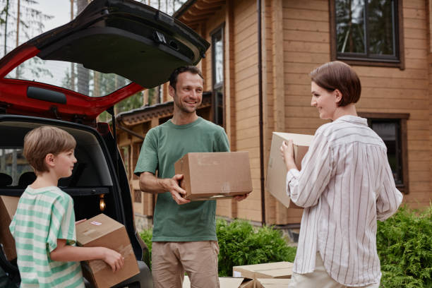 istock Happy family unloading boxes moving into new house in nature 1455235435