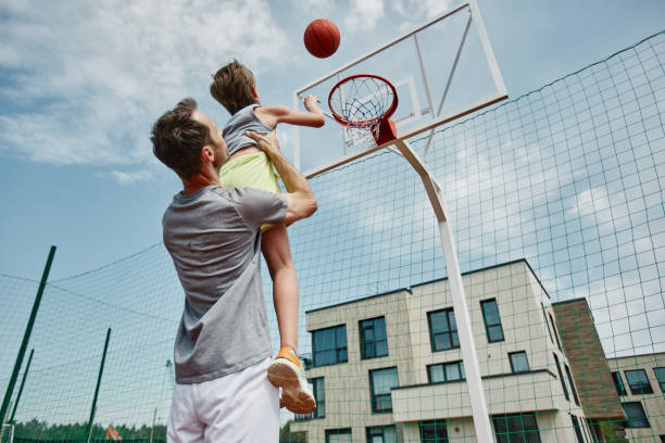 istock Father and son playing basketball together 1455235511