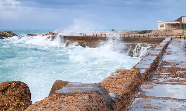 istock Coastal landscape with stone fortifications and breaking waves 1455235753