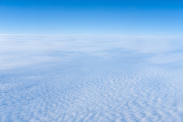the view from the plane window of dense curly clouds and the blue stratosphere. cloudscape. blue sky and white cloud - cloud cloudscape stratosphere above imagens e fotografias de stock