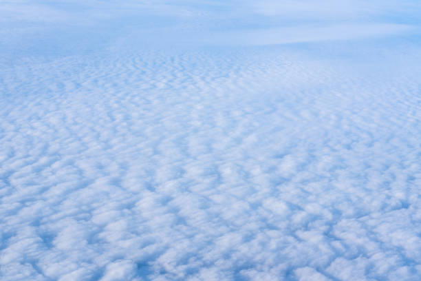 the view from the plane window of dense curly clouds and the blue stratosphere. cloudscape. blue sky and white cloud - cloud cloudscape stratosphere above imagens e fotografias de stock