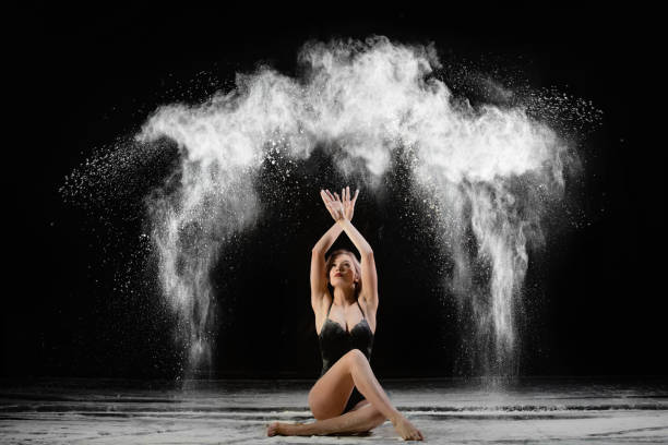 young slim woman with spread flour on the air - motion art naked studio shot imagens e fotografias de stock