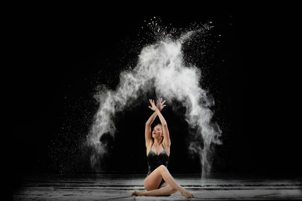 young slim woman with spread flour on the air - motion art naked studio shot imagens e fotografias de stock