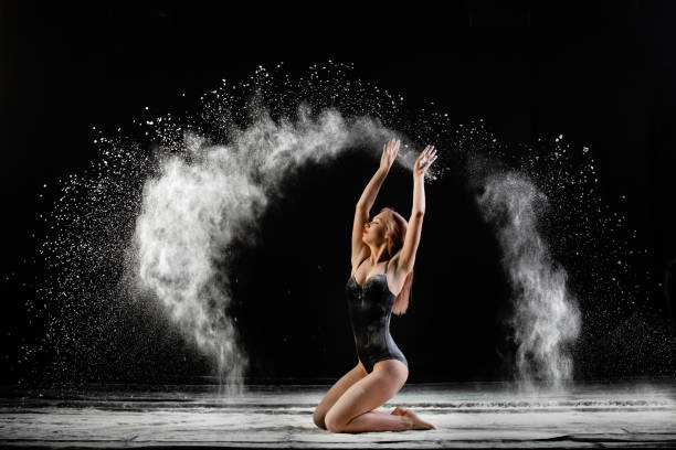 young slim woman with spread flour on the air - motion art naked studio shot imagens e fotografias de stock