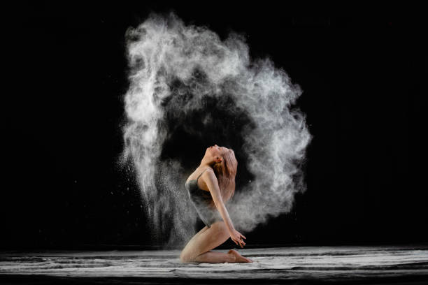 young slim woman with spread flour on the air - motion art naked studio shot imagens e fotografias de stock