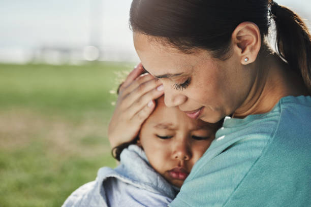 pocieszenie, mama i smutne dziecko z niepokojem, strachem i frustracją z powodu problemów wspieranych i kochanych przez mamę. rodzina, smutek i mama niosąca nastrojowe i wściekłe dziewczynki lub dziecko w parku na świeżym powietrzu - baby toddler young women outdoors zdjęcia i obrazy z banku zdjęć